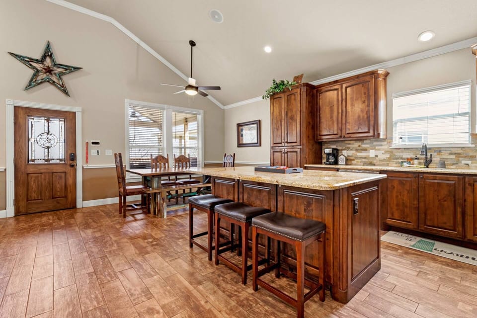 Enter with Texas flair through our glass star mosaic front door, revealing a welcoming sight as it opens into the dining and kitchen area.