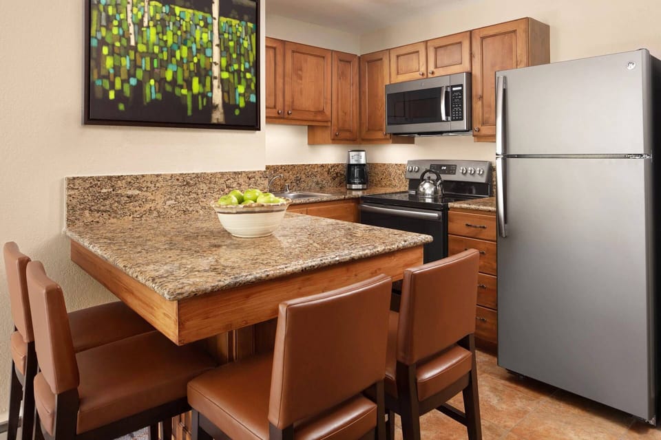The Studio Kitchen comes with a table for 4, full refrigerator, microwave, oven, stove top, coffee maker, and dishwasher.