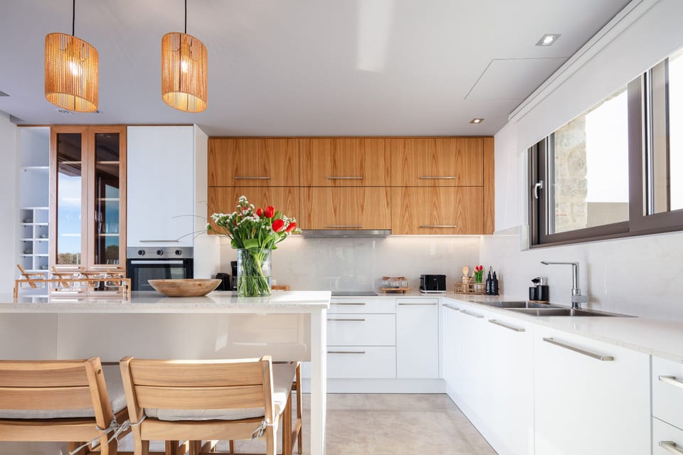 The fully equipped kitchen boasts a convenient island counter with four stools.