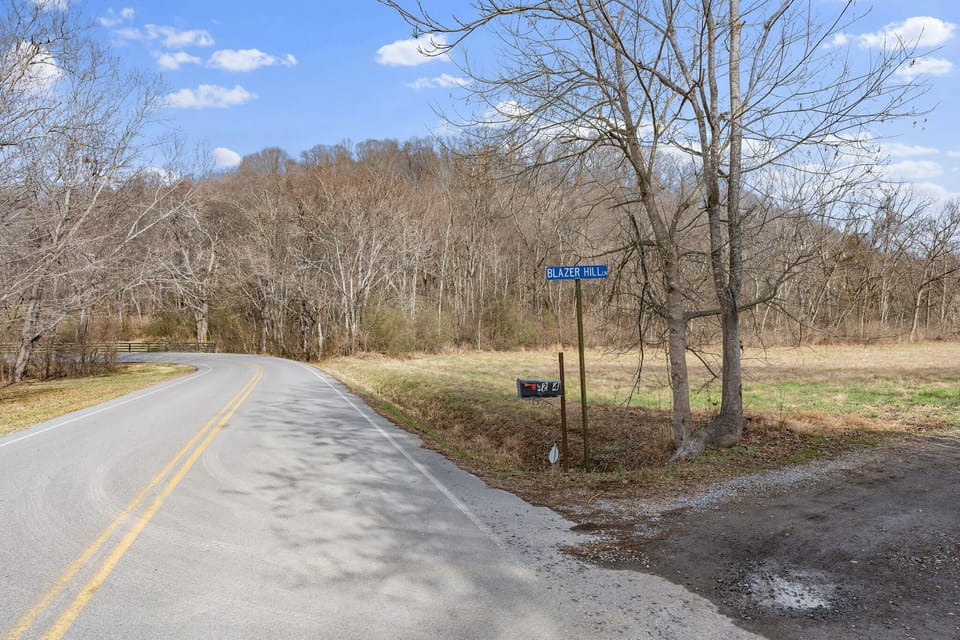 Rural road with signage, a scenic route through a natural landscape.
