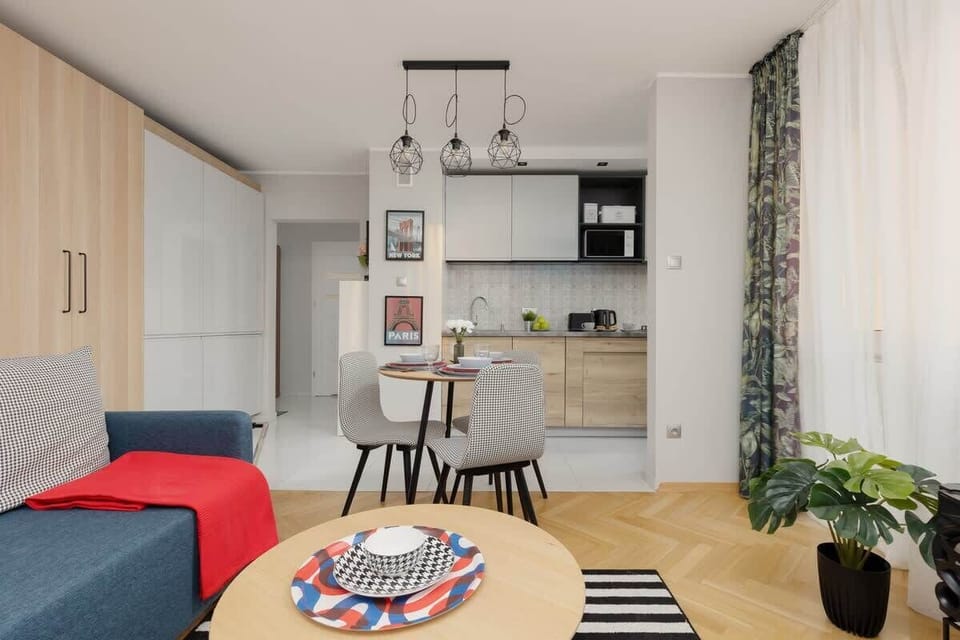 Living room with a fold-out corner sofa, TV and kitchenette