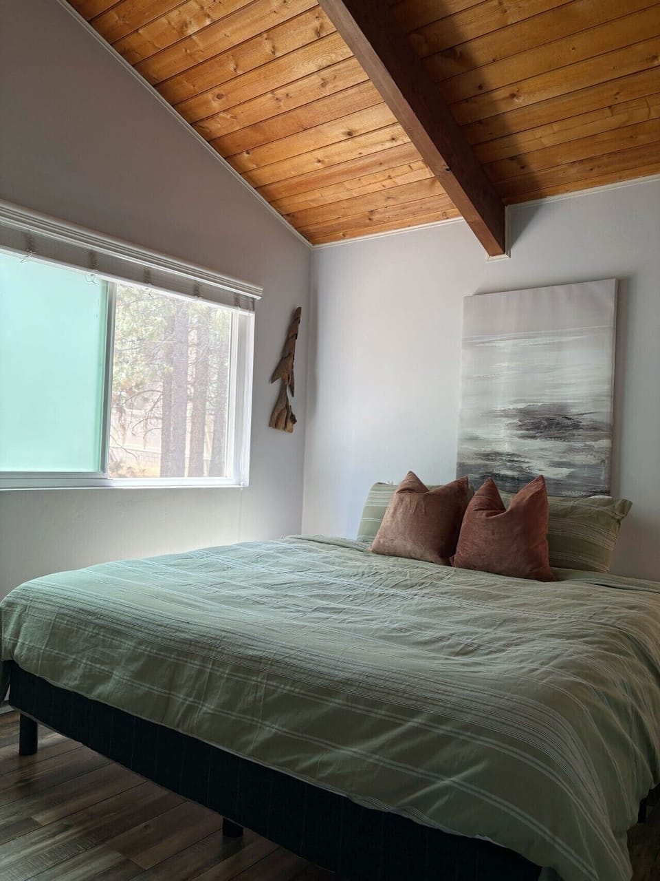 Wake up looking at the trees in this cozy King bed.