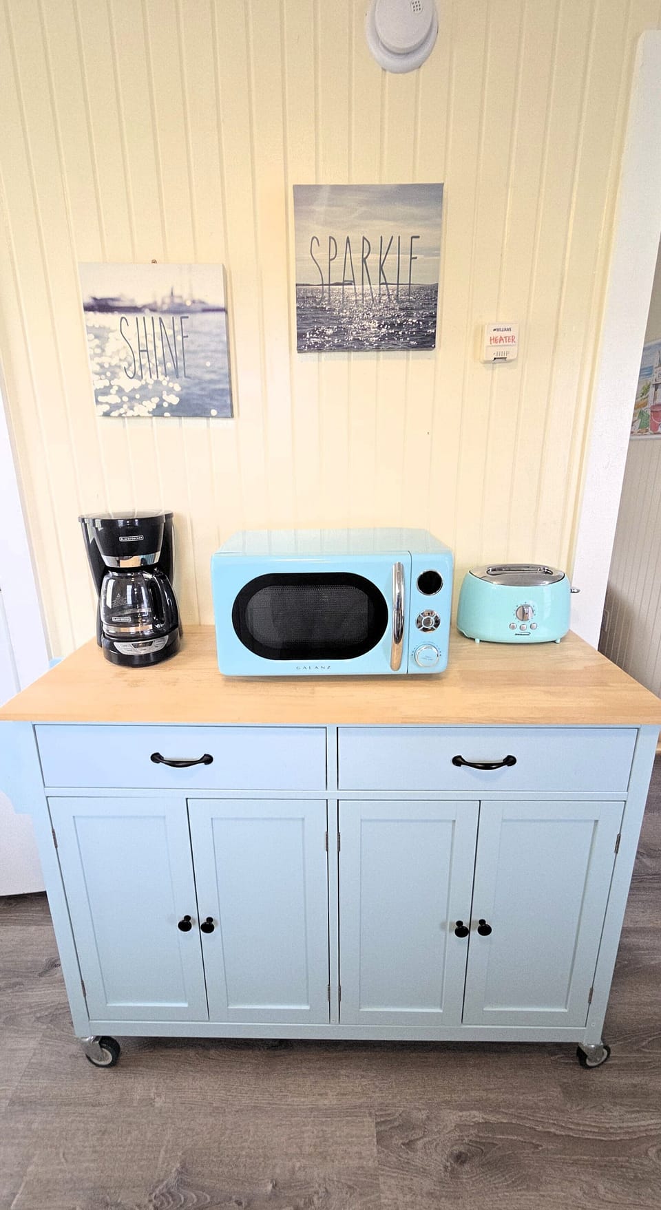 A coffee maker and kitchen essentials are provided.