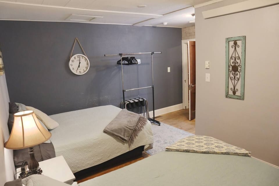 Back Bedroom with two queen beds and private bathroom access. 