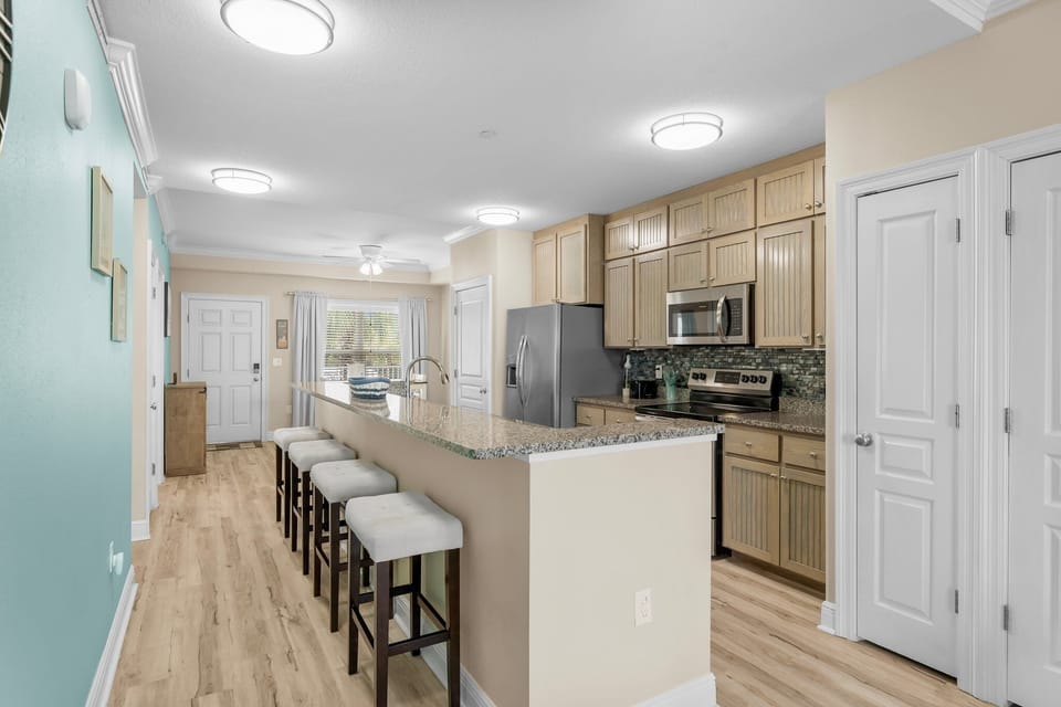 Your fully equipped kitchen with granite counters and breakfast bar makes meal prep a breeze during your stay.