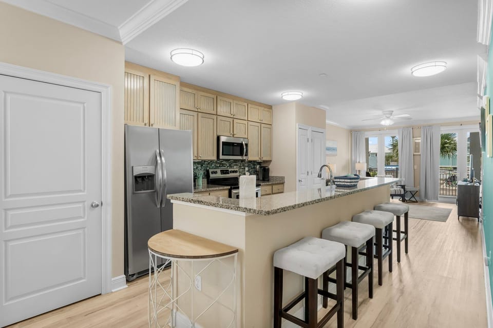 Gather at your spacious kitchen island for morning coffee as ocean breezes flow through open balcony doors.