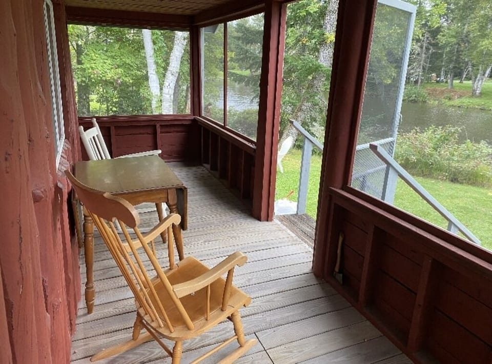 Screened in porch which faces the thoroughfare