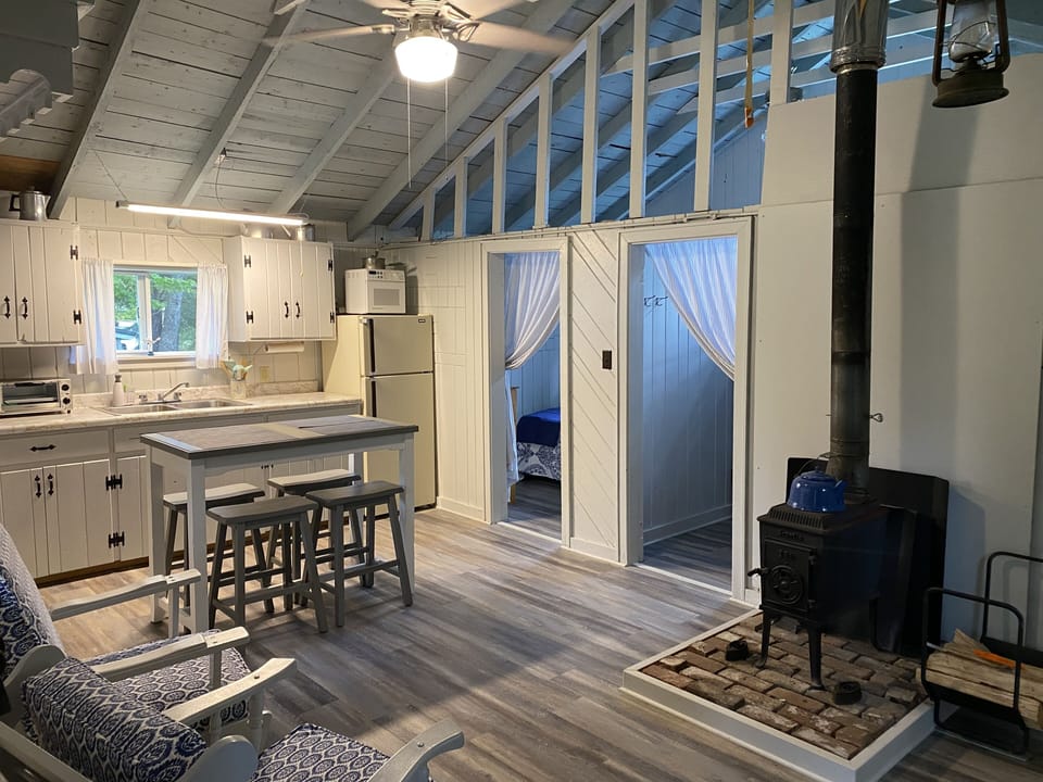 Large room with seating and kitchen area.