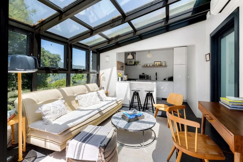 Relax in a well-lit living area with plush seating and a warm, welcoming feel.