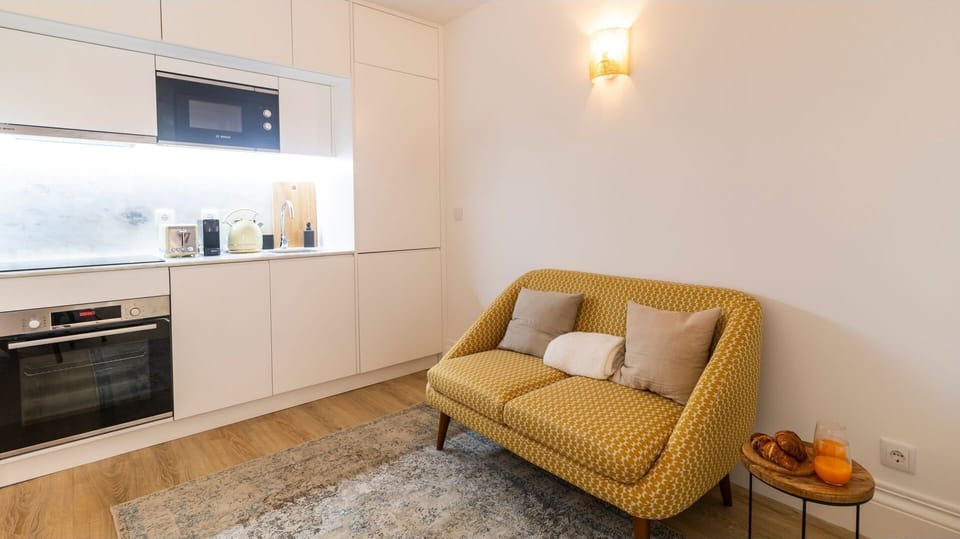 Prepare delicious meals in this sleek, fully-equipped kitchenette, then effortlessly transition to relaxing on the stylish two-seater sofa with a fresh coffee or a morning pastry. This clever layout ensures you have everything you need for comfort and con