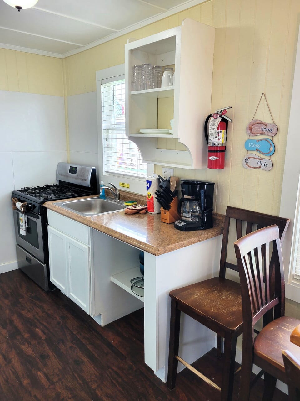 The kitchenette has a gas stove, refrigerator, microwave, and coffee maker.