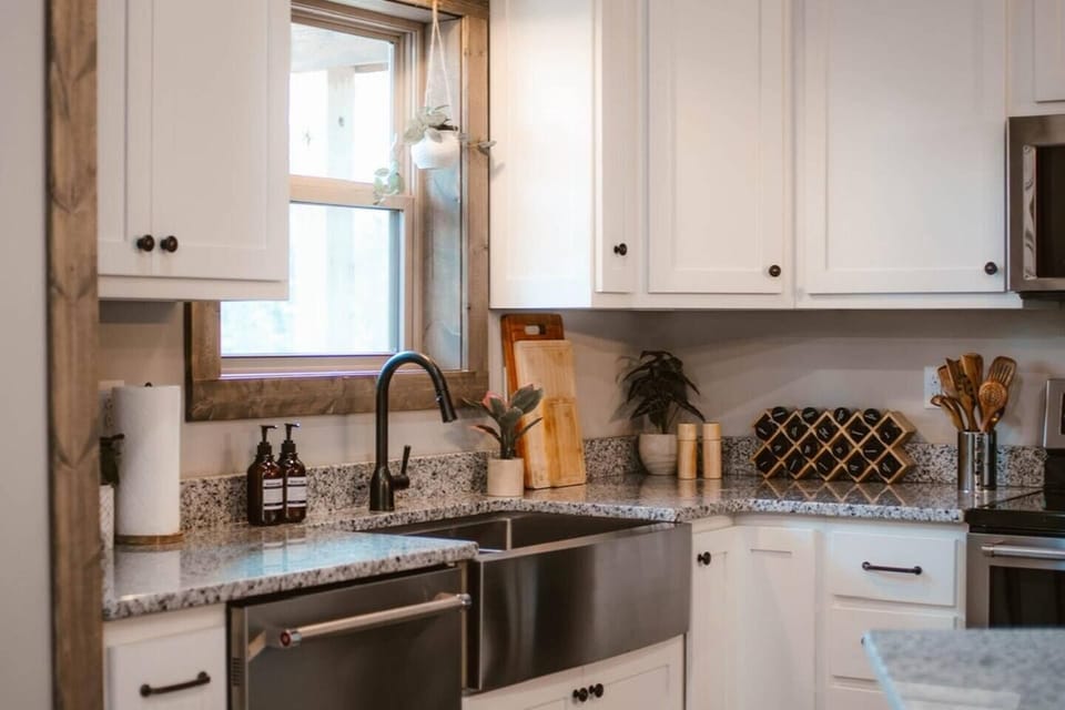 Farmhouse sink, spices, cutting boards, pots & pans, baking essentials for all you need to stay in and cook.