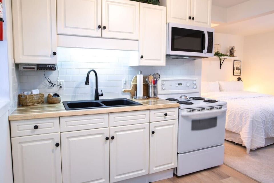 The kitchen has a stove, oven, and microwave.