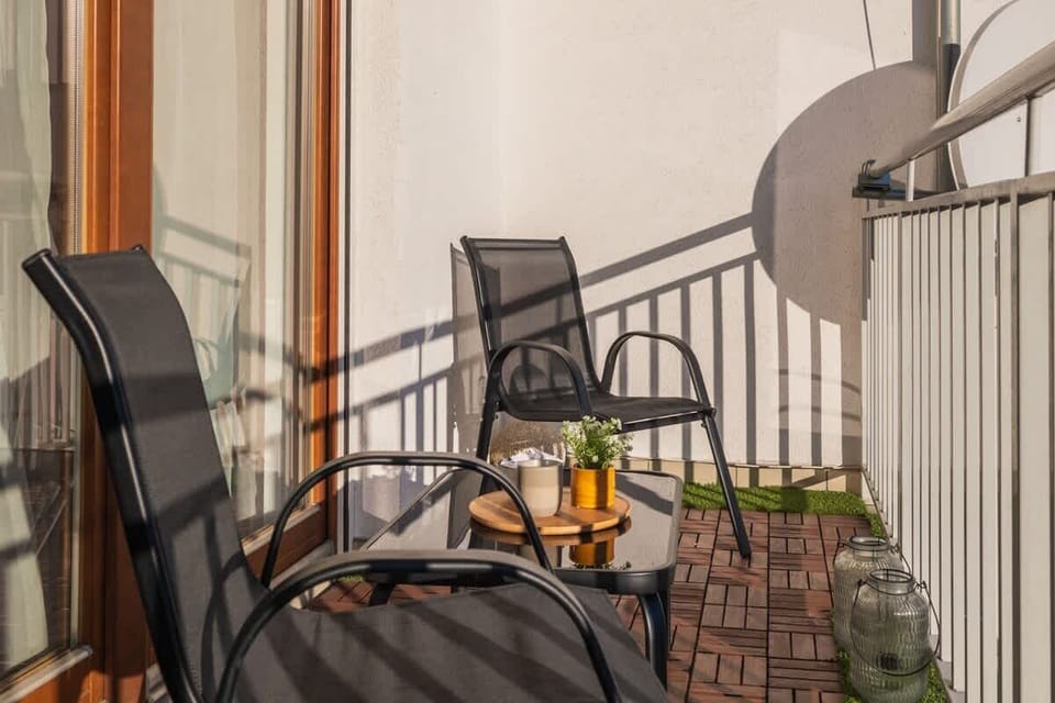 Balcony with chairs and table. 