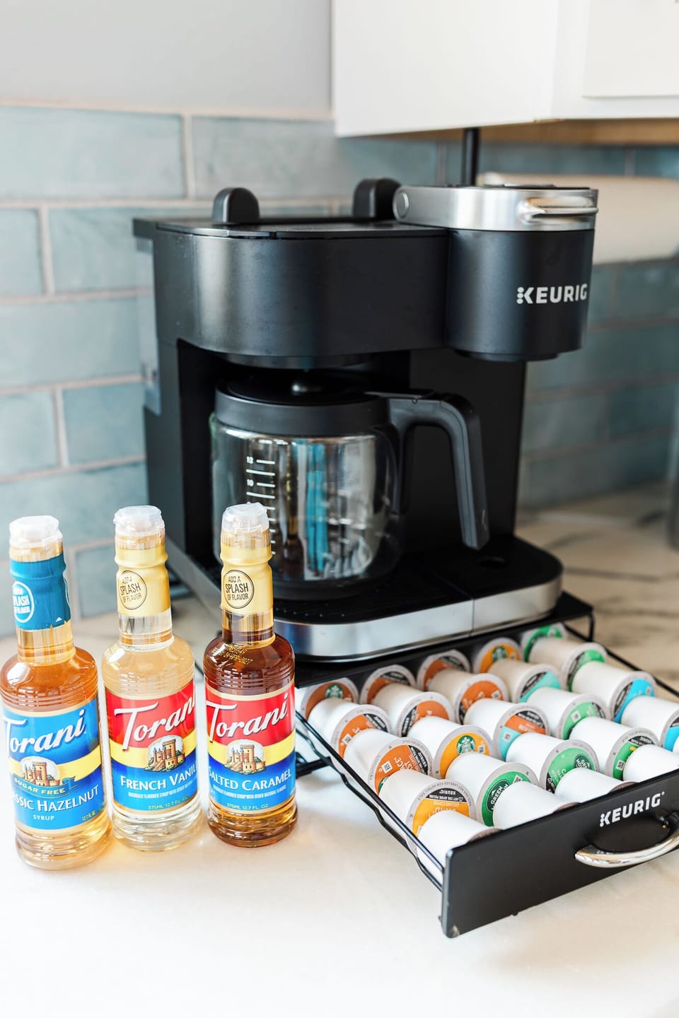 Coffee station with all the different flavors of coffee pods as well as syrups.