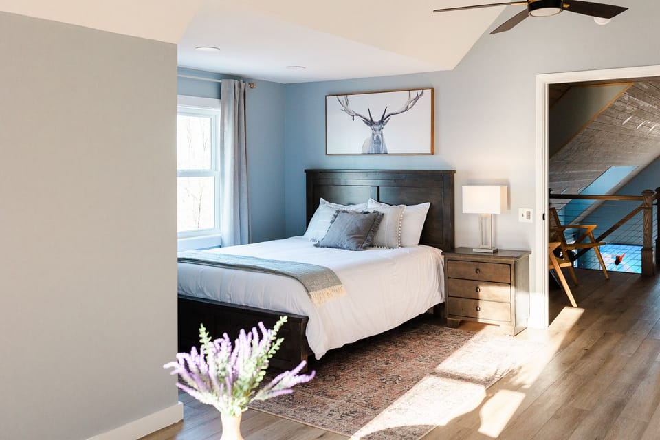 Loft bedroom with 1 queen bed and 1 sofa bed that opens up to full size bed.