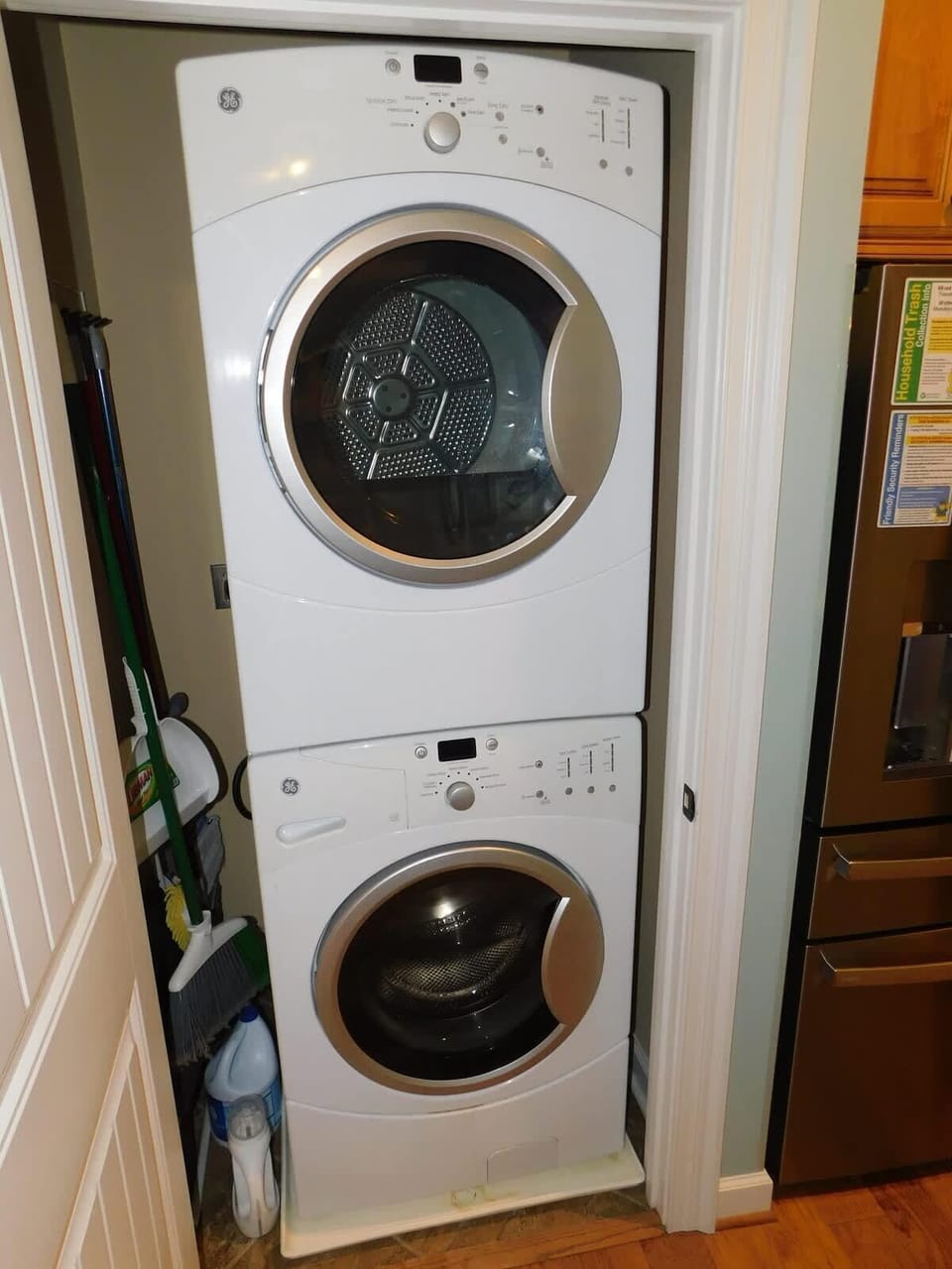 Compact laundry nook with modern stacked washer and dryer