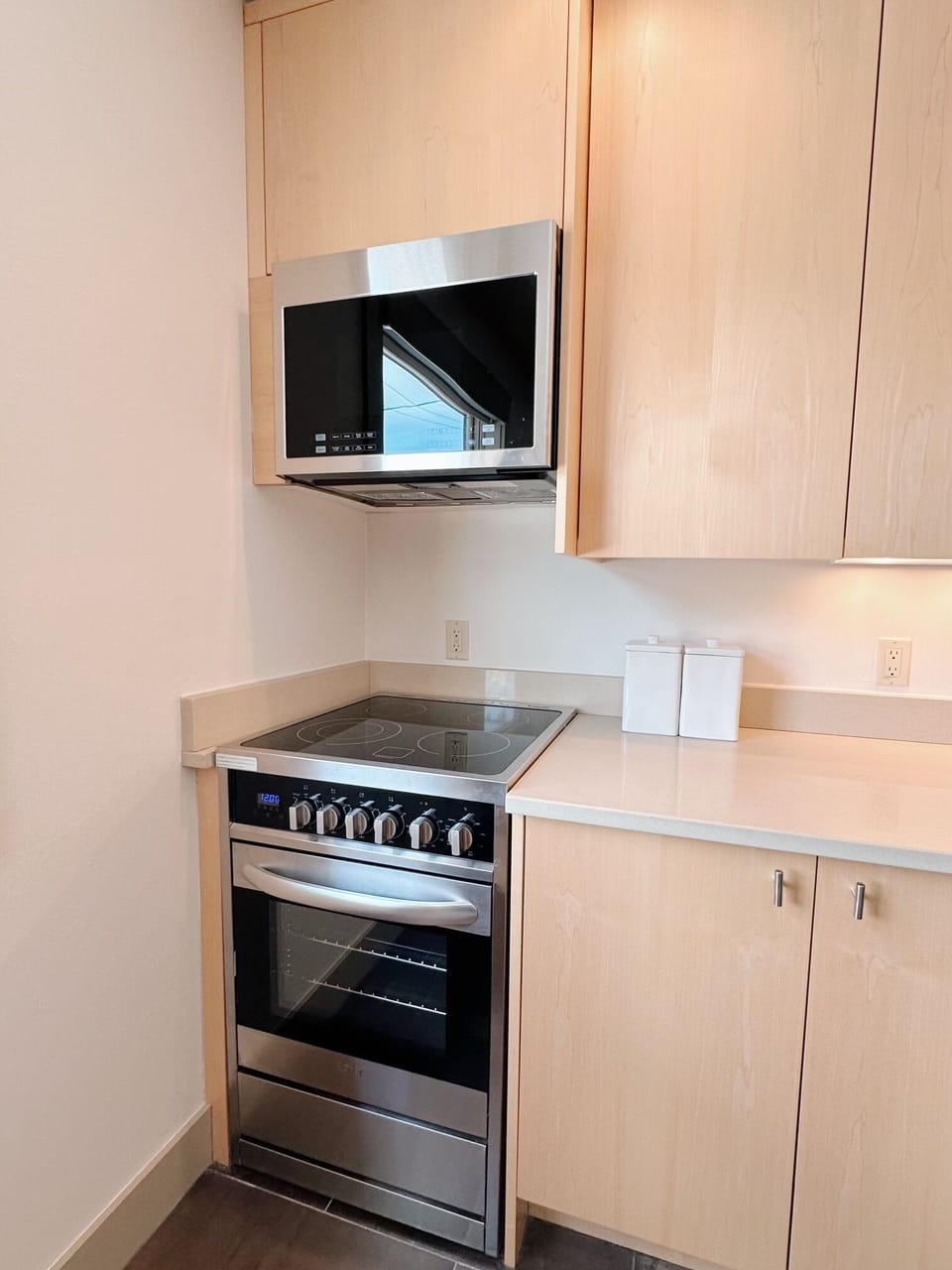 Pretty, custom maple cabinetry with built in microwave and electric range.