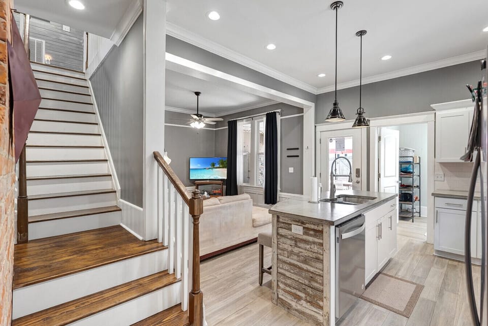 Modern Stairway & Open Kitchen View – A seamless blend of rustic charm and modern finishes.