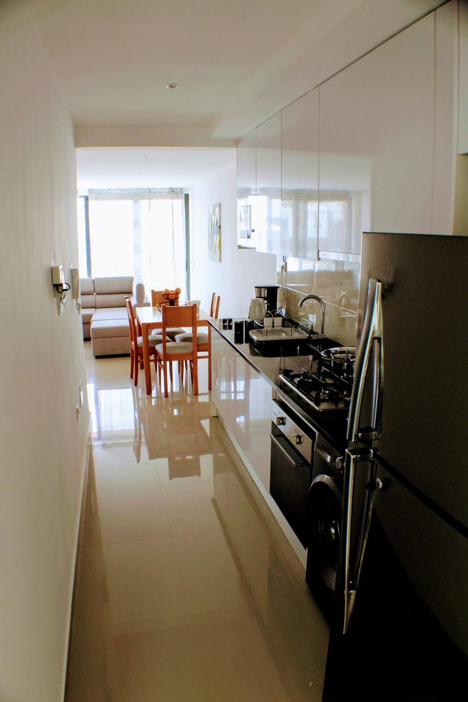 Full kitchen with gas stove and oven, refrigerator, pots, pans, dinnerware