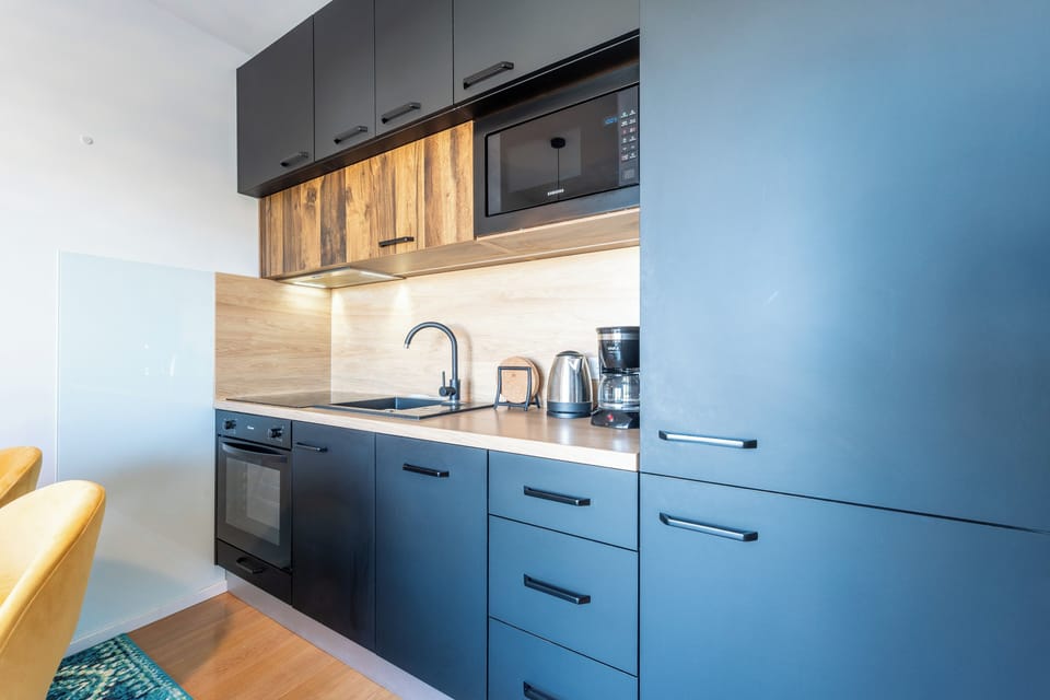 Design Apartment | Private kitchen | Full-size fridge, microwave, oven, stovetop