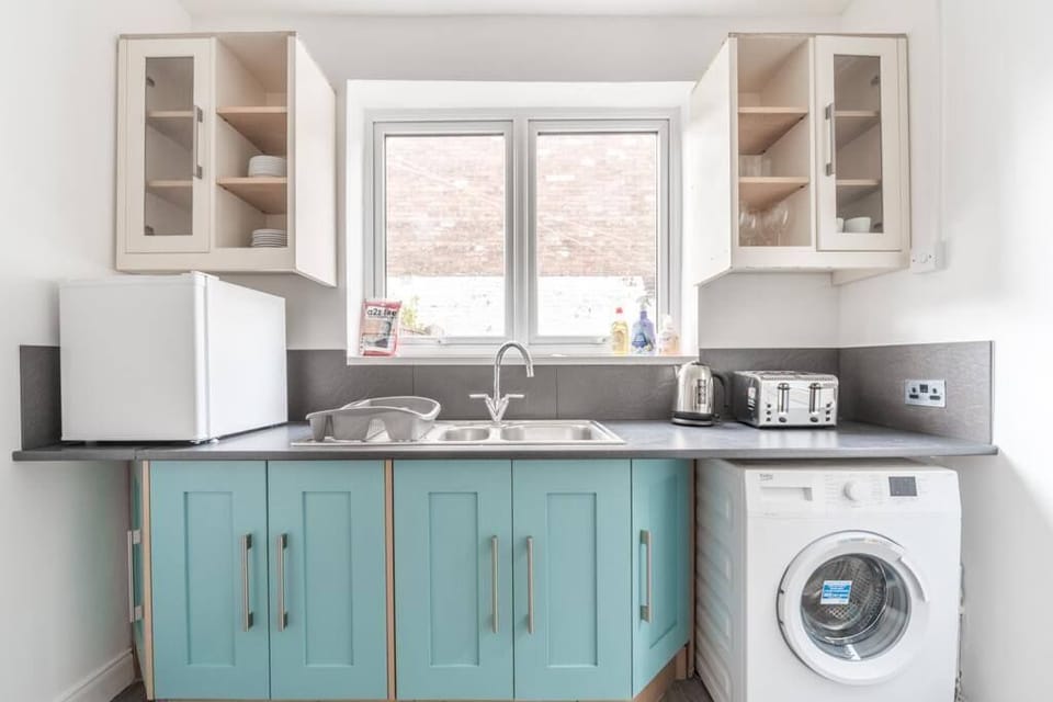 Well-equipped kitchen essentials with a washer, combining convenience and functionality for all your cooking and laundry needs.