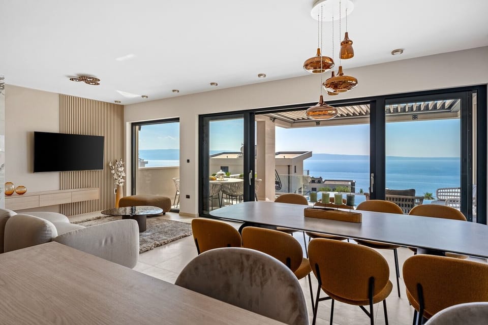Living area with direct exit to covered outdoor dining area and pool