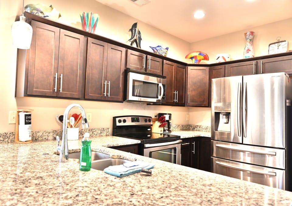 Stylish kitchen with granite, wood, stainless steel & vibrant decor