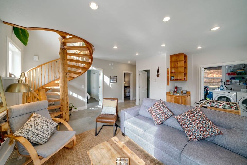 Beautiful craftsman spiral wood staircase to the lower living area, 2 bedrooms, full bath, wet bar, laundry room, foos ball table and access to lower deck. TV, Games, books and DVD player.