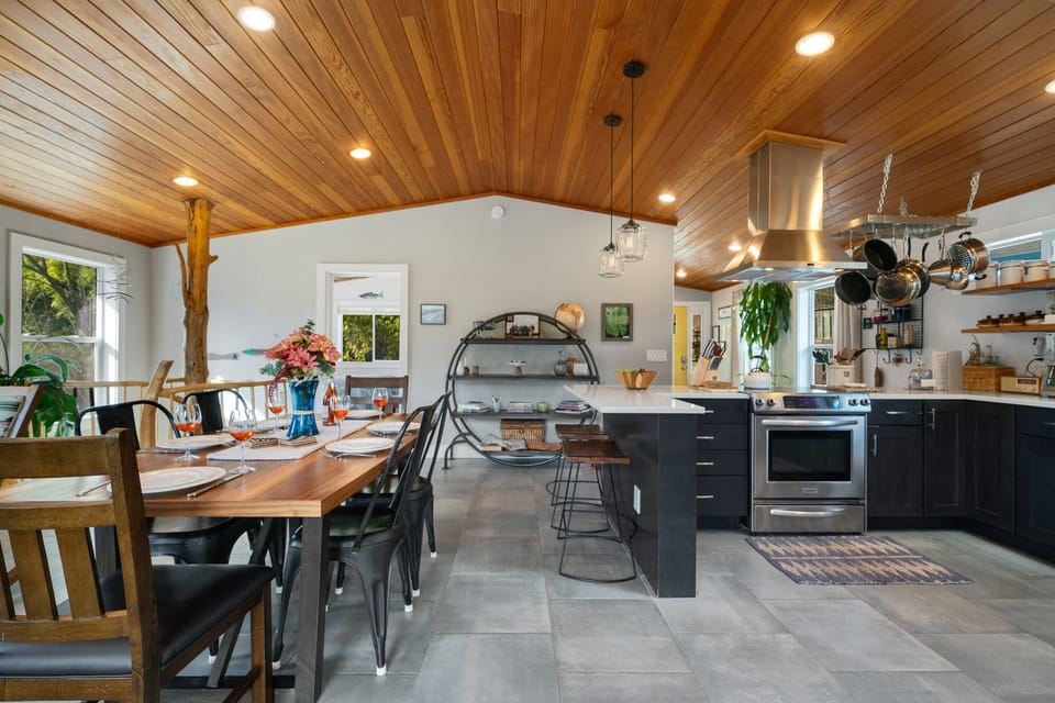 Open Floor plan with Dining table for 6 plus Bar seating. Open to the Living room with Streaming TV, Gas Fireplace, Access to upper deck.
