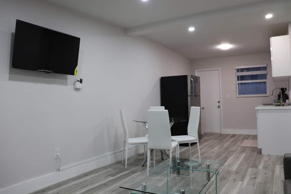 Dining area equipped with a white table and chairs.