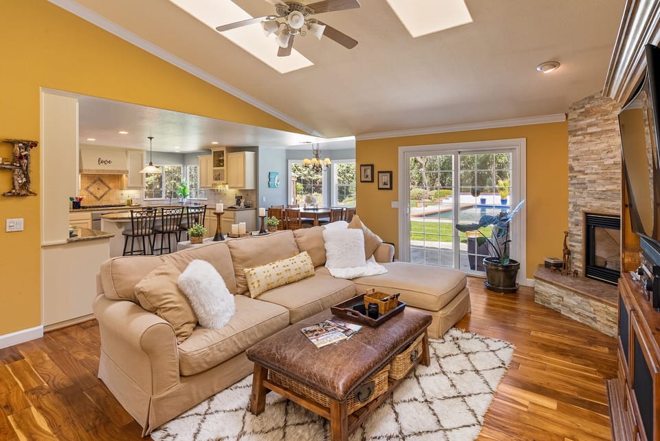 Living room looking at dining nook, kitchen, slider to back yard