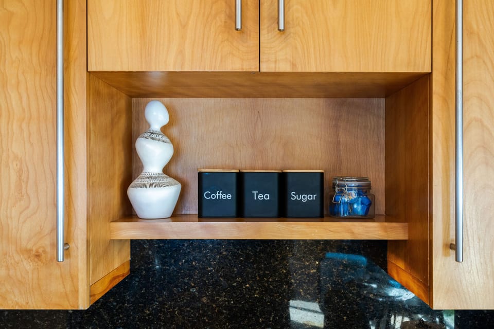 Kitchen is stocked with coffee and tea as well as olive oil and spices.