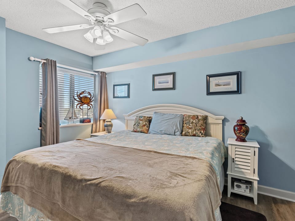Bright coastal bedroom with king bed, natural light, and calming decor