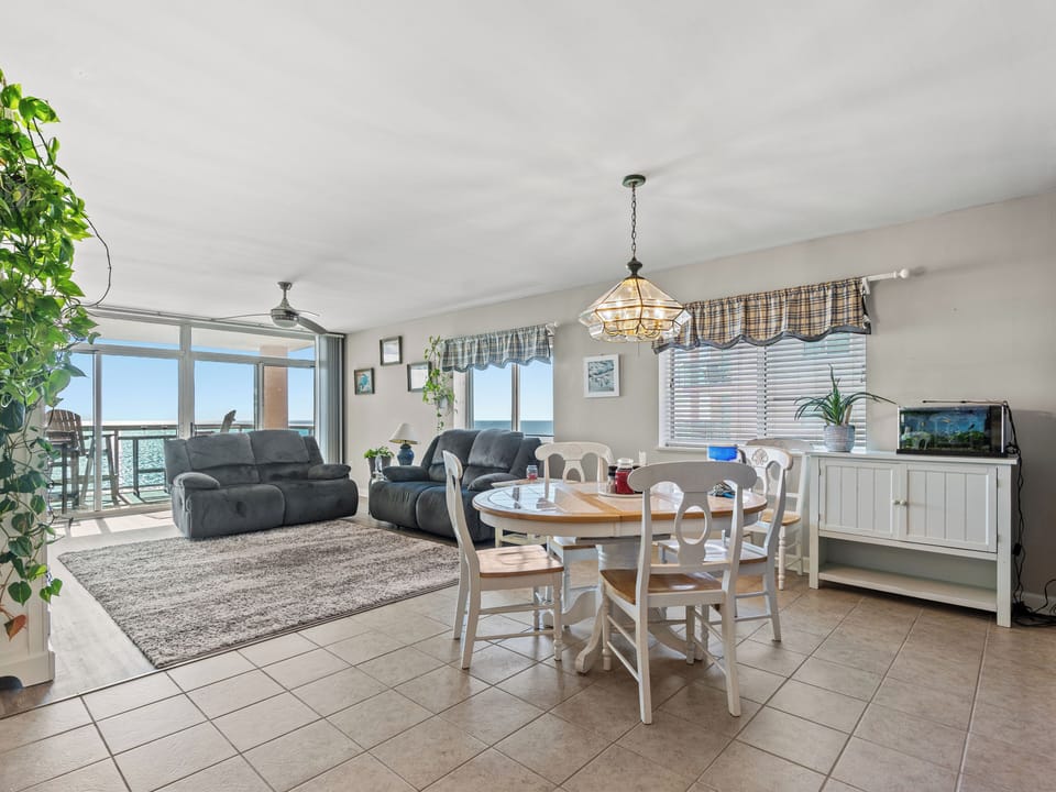 Bright coastal living space with ocean views and balcony access