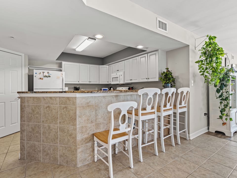 Bright open kitchen with breakfast bar seating for five
