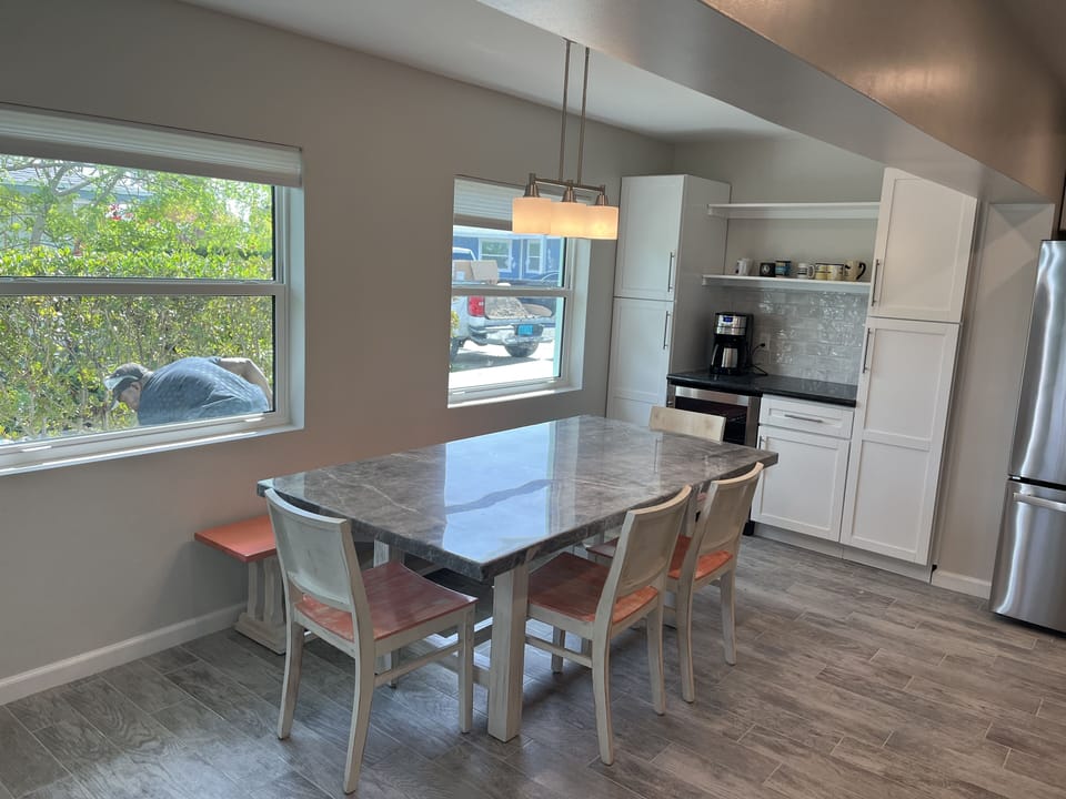 Kitchen table with beverage station and mini beverage fridge.