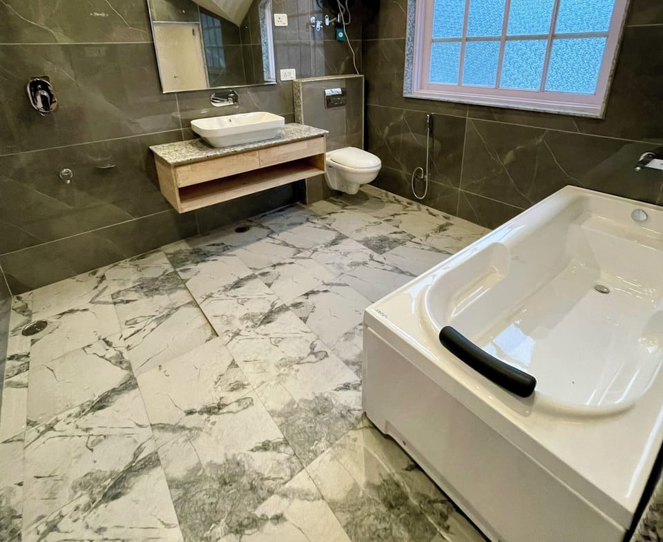 Deluxe Room | Bathroom | Hair dryer, slippers, towels, soap