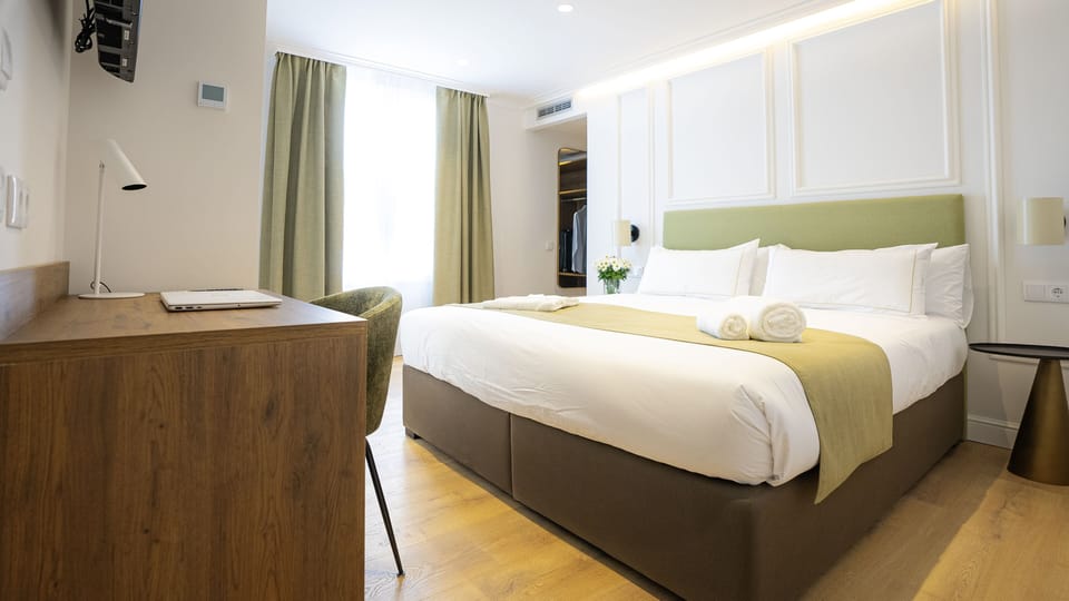 Deluxe Room, 1 Queen Bed, Balcony, City View | Minibar, in-room safe, individually decorated, individually furnished