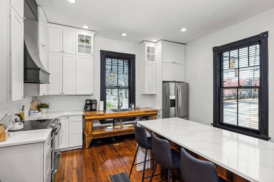 The kitchen includes stainless steel range, microwave, dishwasher, sink, and fridge.
