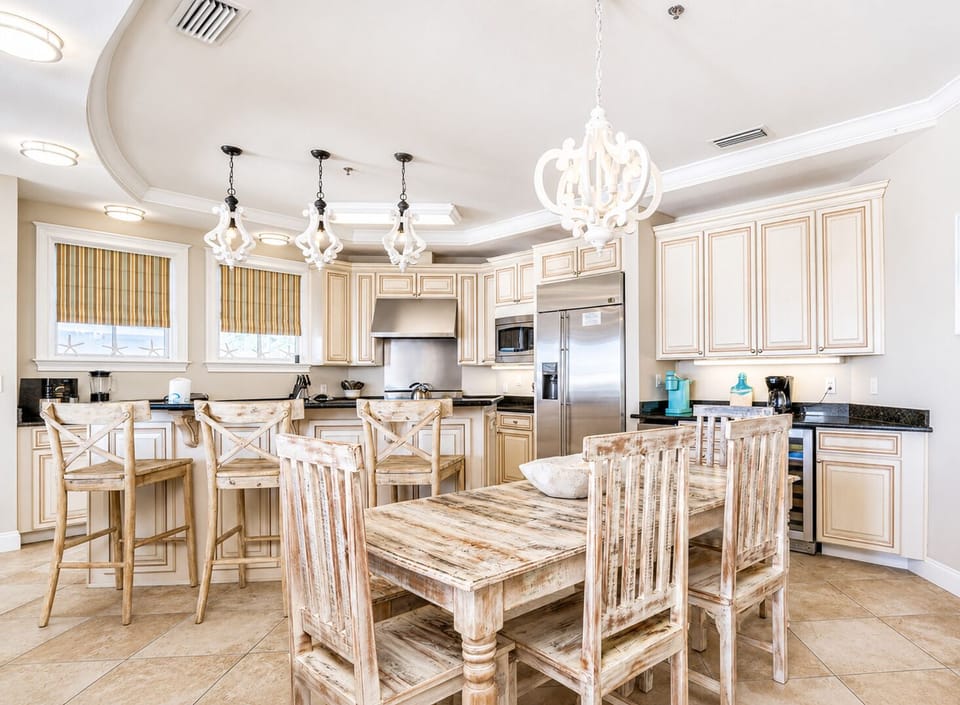 Your gourmet kitchen welcomes you with granite counters, elegant pendant lighting, and a rustic dining table perfect for sharing meals.