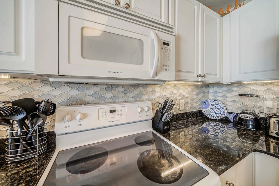 The fully equipped kitchen features granite countertops and has everything you need to cook meals for family & friends.