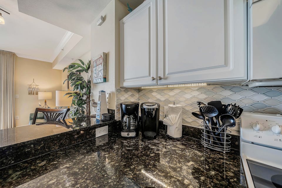 The fully equipped kitchen features granite countertops and has everything you need to cook meals for family & friends.