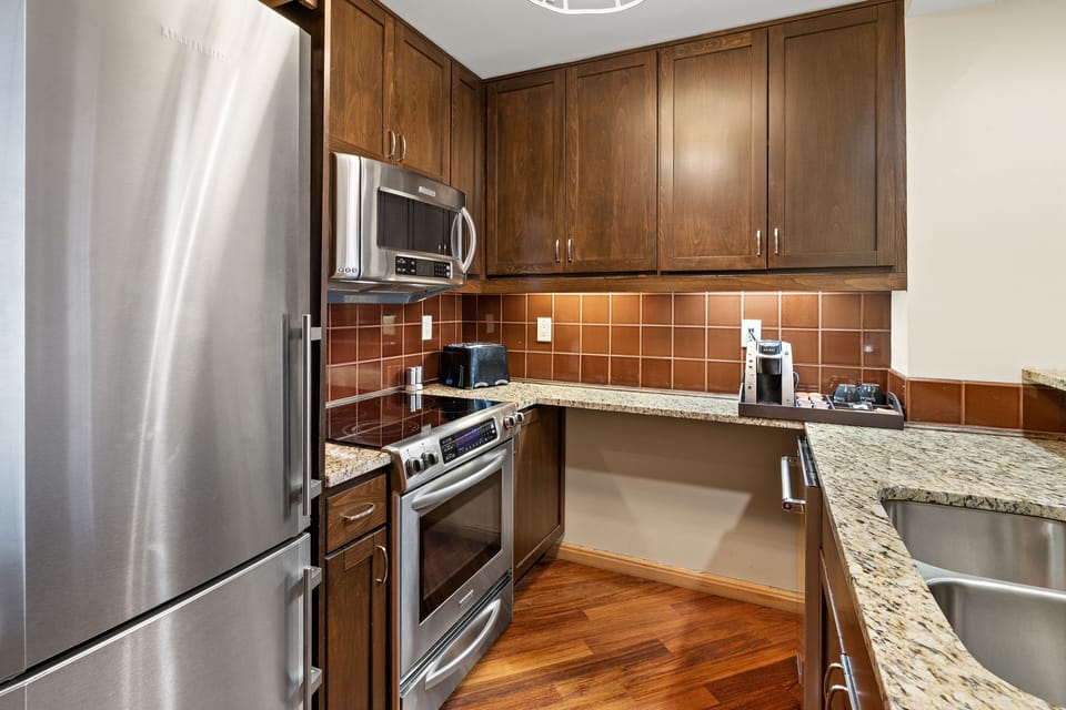 Full-size kitchen with toaster, Keurig machine, pots, pans, dishes, utensils. 
