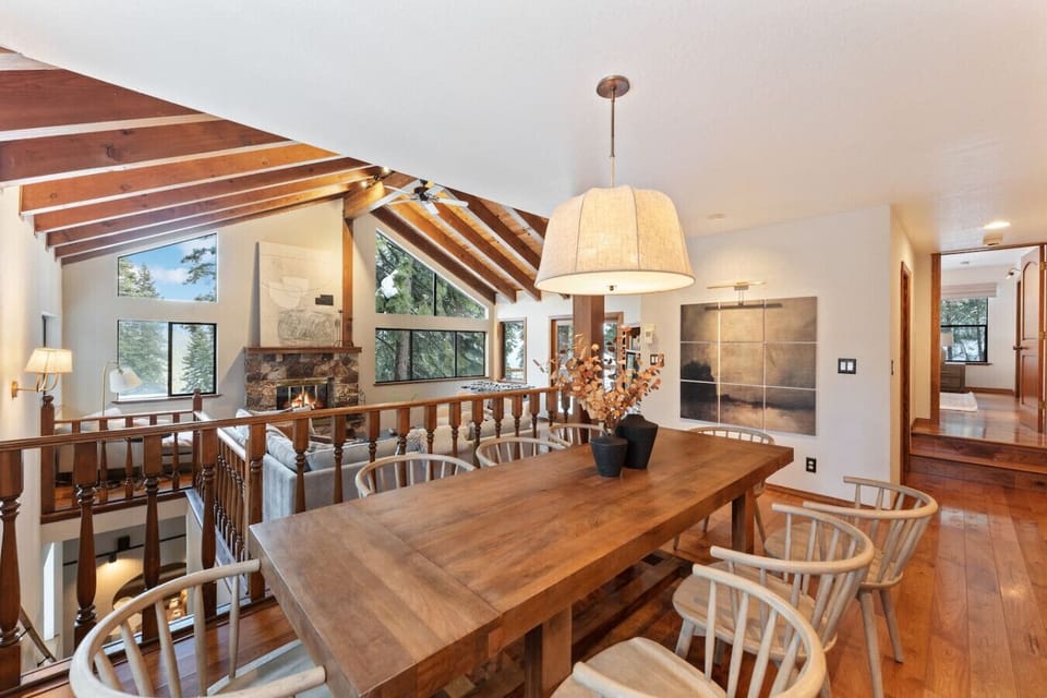 Stunning designer dining area with rustic wood accents, vaulted ceilings, and forest views!
