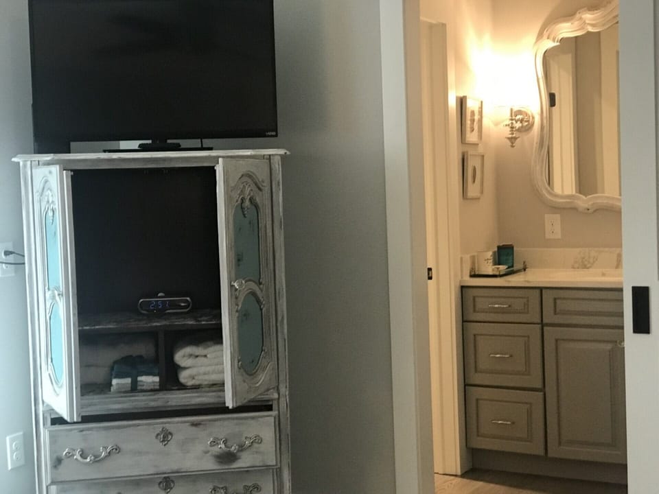 Armoire is a fancy French word for a wardrobe. Don't forget a streaming media device for the Vizio TV.