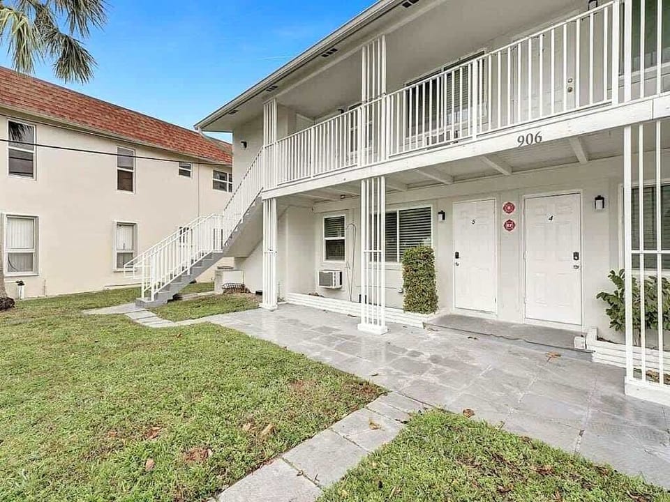 Building entrance with unit number and balcony