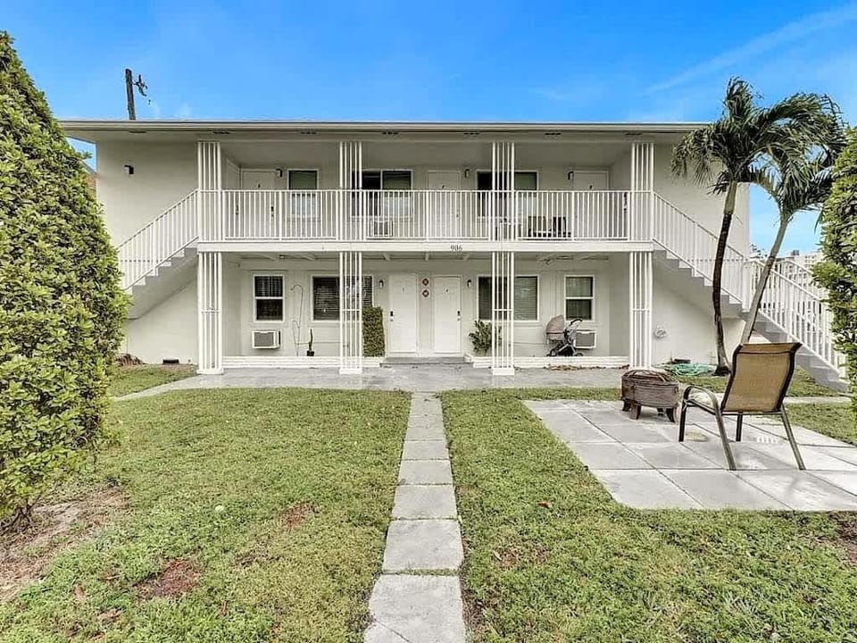 Building exterior with lawn and outdoor seating