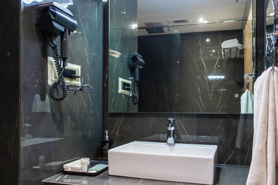 Separate tub and shower, rainfall showerhead, free toiletries, bathrobes
