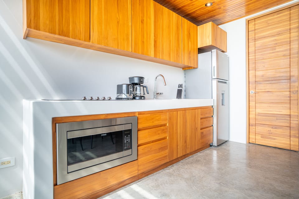 A beautifully designed kitchen with modern appliances and warm natural wood finishes.